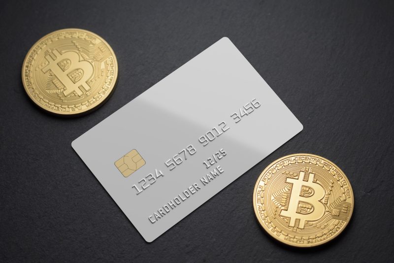 white-plastic-card-with-bitcoin-coins-on-black-bac-2021-09-01-03-32-10-utc.jpg